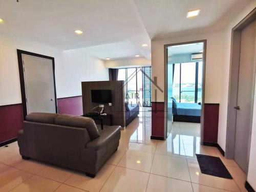 a living room with a couch and a television at PD D’Wharf Amazing Seaview Suite 9 (Up to 6 Pax) in Port Dickson