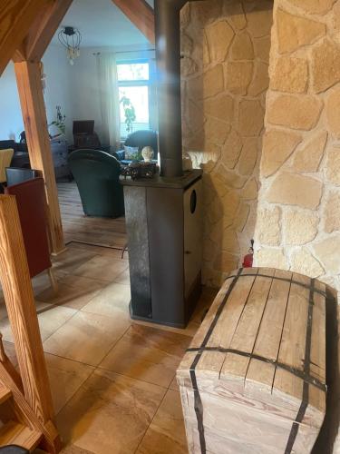 a living room with a wood stove in a house at Tannenhaus Hohen Mistorf in Alt Sührkow