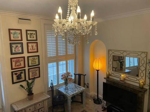 a living room with a chandelier and a mirror at Luxury Apartment Opposite The Shambles in York