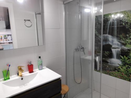 a white bathroom with a shower and a sink at Alojamientos Rurales Inma in Conil de la Frontera