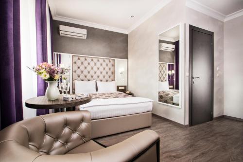 a hotel room with a bed and a table at BonApart Hotel by UHM in Kyiv