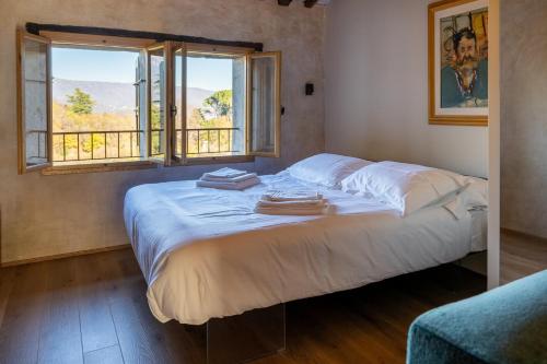 a bed with towels on it in a room with a window at Il Molino in Asolo