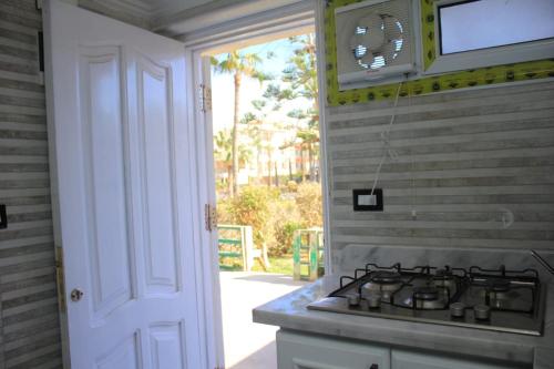 a stove top in a kitchen with a window at JERMA apartments شاليه المعموره in Alexandria