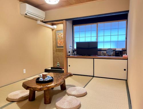 a living room with a table and a large window at 京宿日和 聚楽 Hiyori Juraku in Kyoto