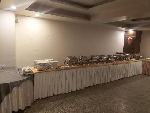 a long table with many plates of food on it at Aalcajars Inn in Patna