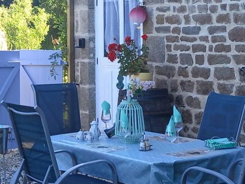 a blue table with a blue table cloth and chairs at Captivating 2-Bed Cottage in Mortain-Bocage in Notre-Dame-du-Touchet