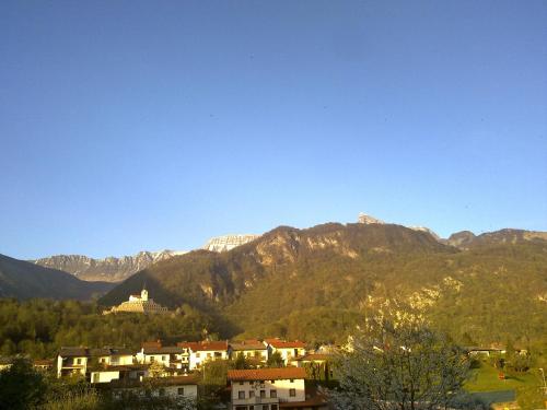 a town in front of a mountain range at Studio Brnat in Kobarid
