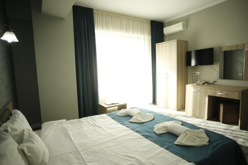 Postel nebo postele na pokoji v ubytování Hotel Agapi Mamaia