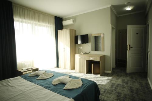 Postel nebo postele na pokoji v ubytování Hotel Agapi Mamaia