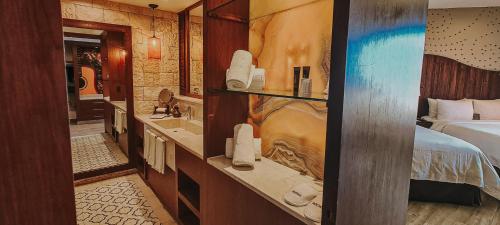 a hotel room with a bed and a bathroom at Hard Rock Hotel Riviera Maya - Heaven Adults Only - All Inclusive in Puerto Aventuras