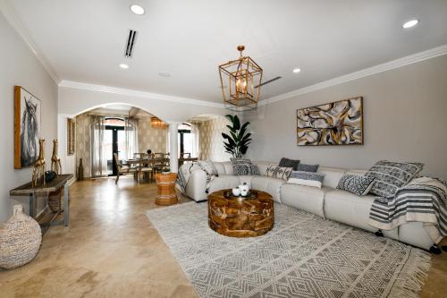 a living room with a couch and a table at Newly Remodeled 5-Bedroom 5-Bath in Tierra del Sol in Malmok