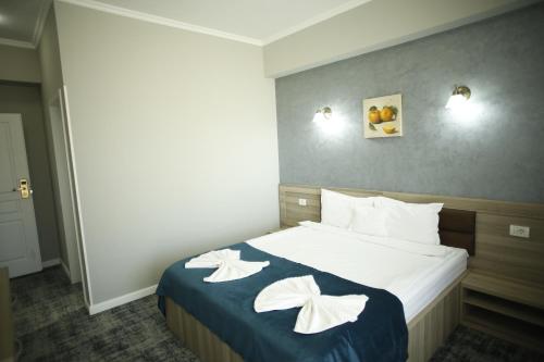 Postel nebo postele na pokoji v ubytování Hotel Agapi Mamaia