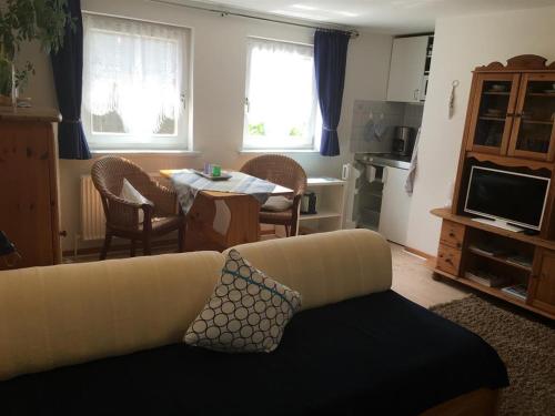 a living room with a couch and a table at Ferienappartement Brandenburg in Flensburg