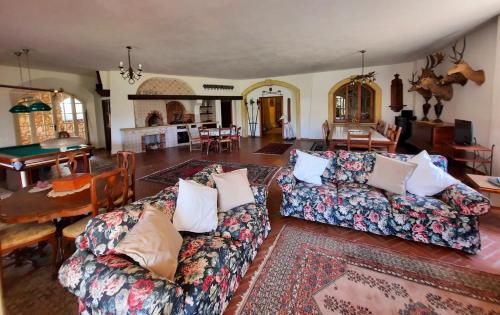 a living room with two couches and a dining room at Villa del Commendatore Sirugo in Avola