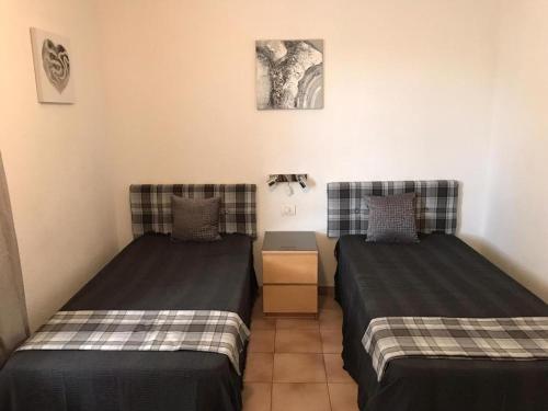 two beds sitting next to each other in a room at One Bedroom Apartment - Los Cristianos in El Guincho