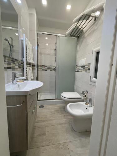 a bathroom with a toilet and a sink and a shower at Casa Cavaliere in Naples