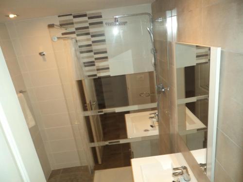a bathroom with a glass shower with a sink at One Bedroom Apartment - Los Cristianos in El Guincho