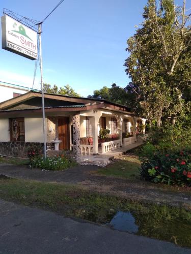 a building with a sign in front of it at Cabinas Smith in Cahuita