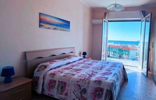 a bedroom with a bed and a large window at TamarHouse Sperlonga Casa Noemi in Sperlonga