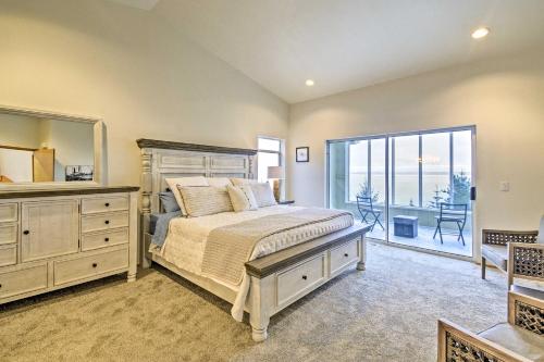 a bedroom with a bed and a large window at Unique Port Ludlow Home with 3 Decks and Hot Tub! in Port Ludlow