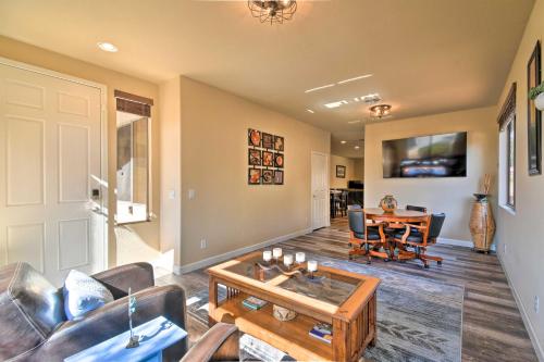 a living room with a couch and a table at 15 Mi to Dtwn Avondale Home with Pool and Yard in Avondale