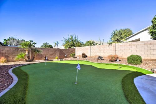 a putting green with a golf ball on it at 15 Mi to Dtwn Avondale Home with Pool and Yard in Avondale