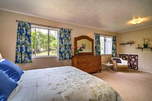 a bedroom with a bed and a dresser and a mirror at Keaau Apartment on Beautiful Acre with Pool and Deck! in Keaau