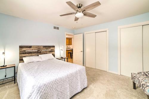 a bedroom with a bed and a ceiling fan at 1 Mi to Tunnel Park Holland Home with Fire Pit in Holland