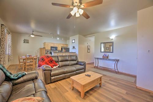a living room with a couch and a coffee table at Near Lake and Trails Show Low Condo with Grill! in Show Low