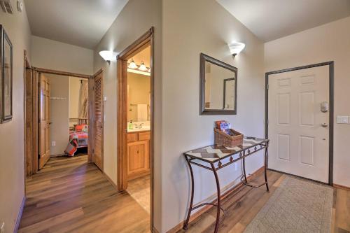 a hallway with a console table and a bathroom at Near Lake and Trails Show Low Condo with Grill! in Show Low