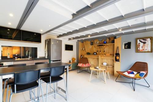 a kitchen with a table and chairs in a room at Air-conditioned duplex apartment with furnished terrace in the city center in Aix-en-Provence