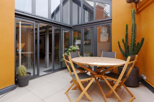 a wooden table and chairs on a patio at Air-conditioned duplex apartment with furnished terrace in the city center in Aix-en-Provence