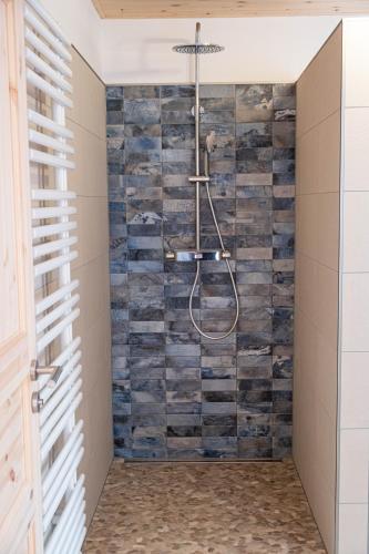 a bathroom with a shower made out of wood at Hof Ruemland Ferienwohnungen in Hollingstedt