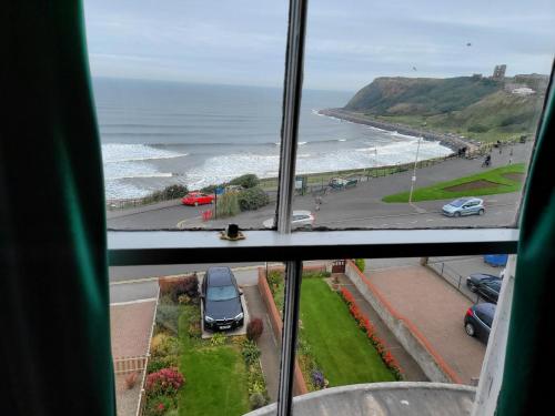 a view of the ocean from a window at Sea view Penthouse flat 6 with fast WiFi and Free PARKING in Scarborough