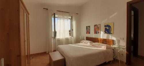 a bedroom with a large bed with a window at Fabiola B & B in Marino