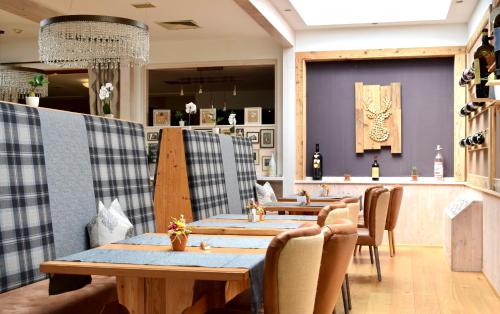 a restaurant with wooden tables and chairs and a bar at Gosau Apartment 407 in Gosau
