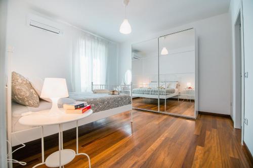 a bedroom with a bed and a table with books on it at Familiaris Pompei Holiday Home in Pompei