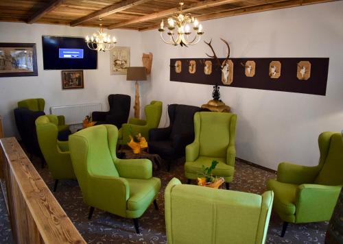 a waiting room with green chairs and a table at Gosau Apartment 407 in Gosau
