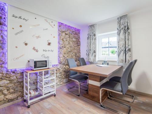 an office with purple walls and a table and chairs at Apartment in Bad Mitterndorf near ski area in Bad Mitterndorf