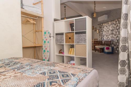 a bedroom with a bed and a book shelf at Miramar Balchik Apartment 10 in Balchik