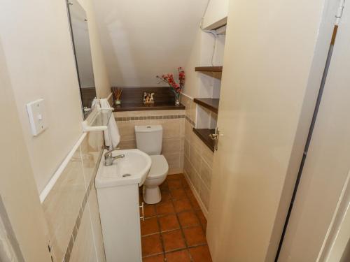 a small bathroom with a toilet and a sink at Tullavilla in Riverstown