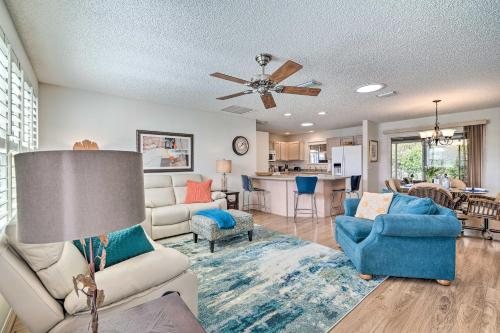 a living room with a couch and chairs and a kitchen at Home in The Villages with Lanai and Private Hot Tub! in The Villages