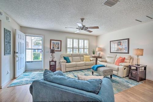 a living room with two couches and a ceiling fan at Home in The Villages with Lanai and Private Hot Tub! in The Villages