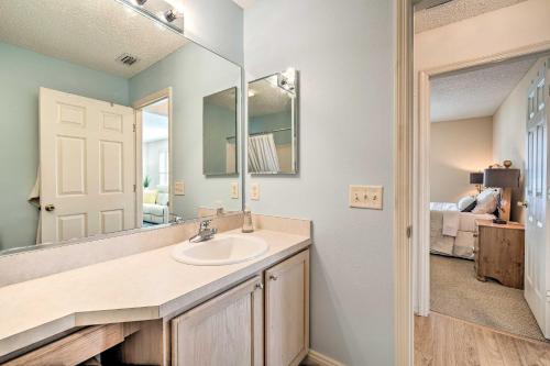 a bathroom with a sink and a mirror at Home in The Villages with Lanai and Private Hot Tub! in The Villages