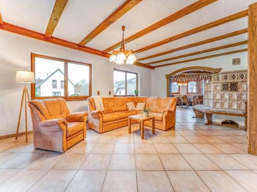 a living room with couches and a table at Spacious flat in Adenau near the N rburgring in Adenau