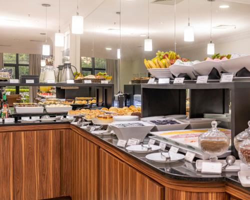 a buffet line with various food items on display at Blue Tree Towers Anália Franco - Tatuapé in Sao Paulo