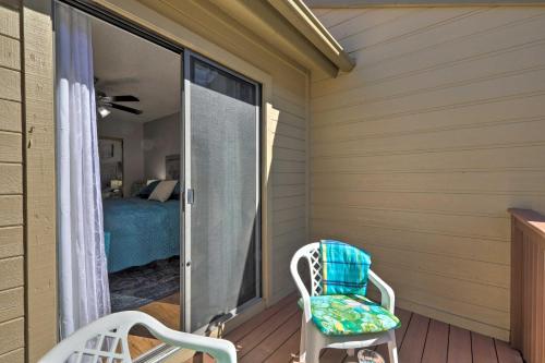 a room with a balcony with a bed and a chair at Flagstaff Condo Less Than 1 Mi to Golfing and Hiking! in Flagstaff