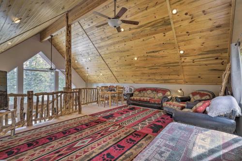 a living room with couches and a wooden ceiling at Serene Pet-Friendly Cabin with Fire Pit and Loft! in Duck Creek Village