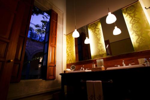 a bathroom with two sinks and a large mirror at Casa Grande Hotel Boutique in Morelia