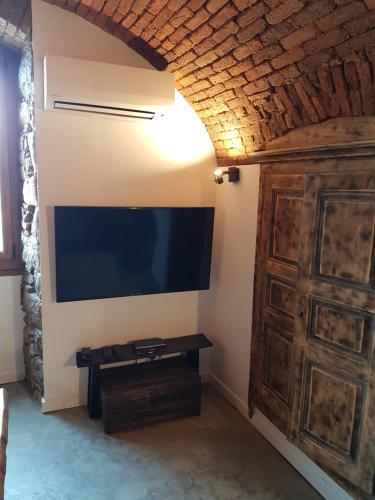 uma sala de estar com uma televisão de ecrã plano na parede em Gite A campinca em Calcatoggio